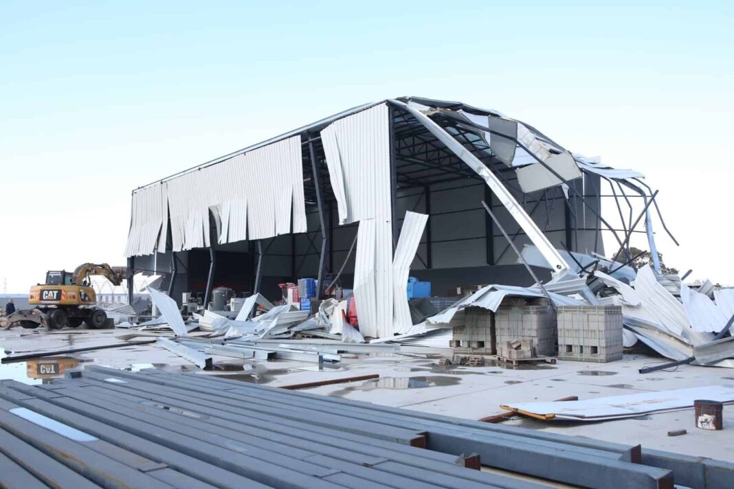 Yıkım alanında büyük metal yapı ve dağınık inşaat malzemeleri görülebilir.